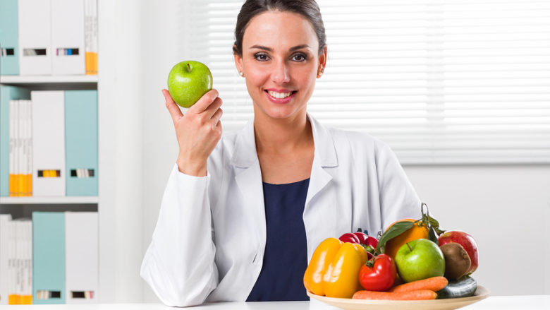 Female Nutritionist Holding A Green Apple